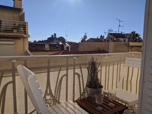 South-facing balcony with a view of Cannes Old Town. Seats 2 people.