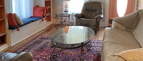 Living room has two comfortable leather recliners and large sleeper sofa