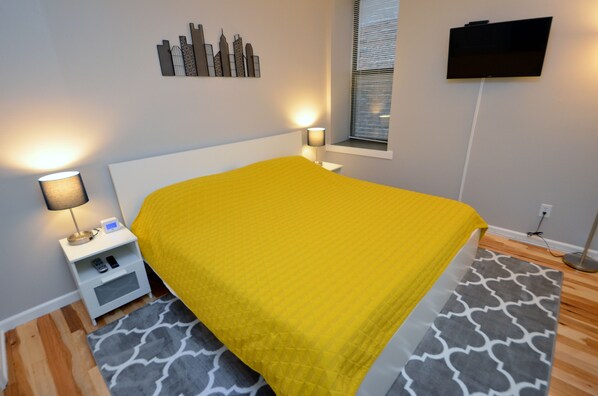 Bedroom With A King Sized Bed, Walk In Closet And 32" Vizio Smart TV