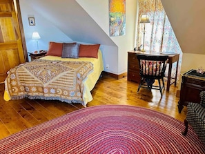 Master bedroom on 2nd floor has two queen beds, desk, dinnette table, kitchenette, and work desk.