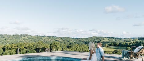 Relaxing on the pool deck surrounded by the picturesque Byron Bay Hinterland