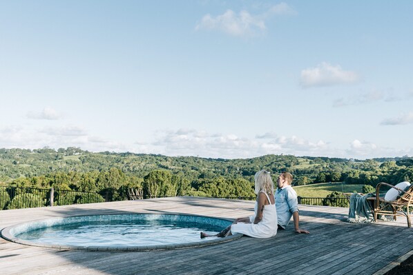 Relaxing on the pool deck surrounded by the picturesque Byron Bay Hinterland