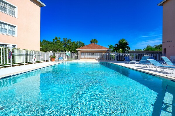 The community pool looks out to the golf course - peaceful &  lush tropical view