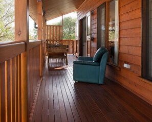 Timber verandah overlooks garden and treetops