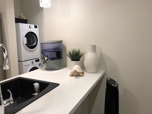 Kitchen island, laundry area in background