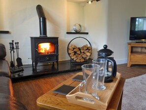 Spacious living area with a wood burner | Tyddyn Eli, Llangwm, near Corwen