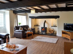 Spacious living area with a wood burner | Tyddyn Eli, Llangwm, near Corwen