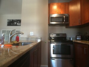 Kitchen with stove, microwave and all that you need for cooking a good meal