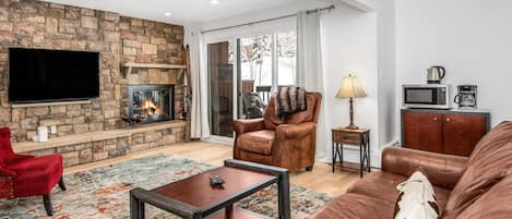 Spacious living room with open floor plan and fireplace