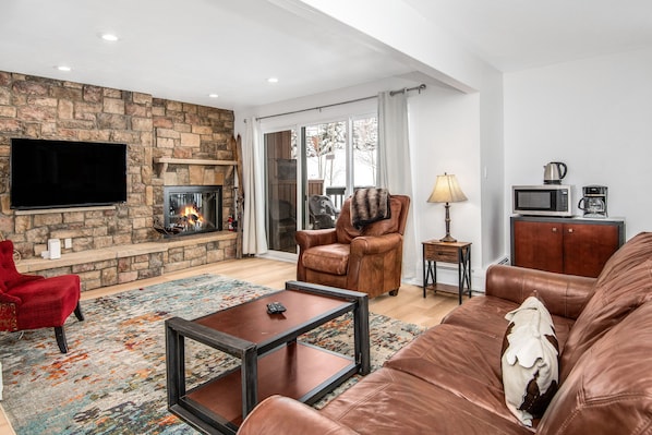 Spacious living room with open floor plan and fireplace