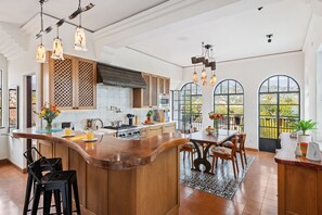 Contemporary kitchen with arched windows and hand-blown glass pendant lights