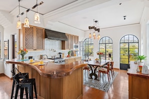 Contemporary kitchen with arched windows and hand-blown glass pendant lights
