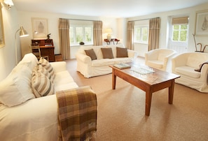 Ground floor: Comfortable sitting room with electric wood burner and comfortable sofas