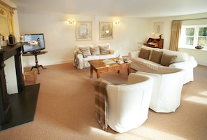 Ground floor: Comfortable sitting room with electric wood burner and comfortable sofas