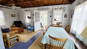 Dining area with living room and sleeping porch beyond