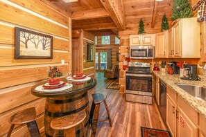 Seating for 4 at a whiskey barrel table and an updated kitchen.