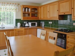 Well equipped kitchen/ dining room | Fairways Cottage, Belford, near Bambugh