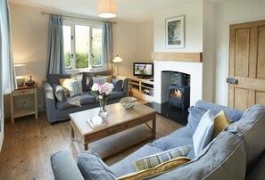 Ground floor: Open plan sitting room with wood burning stove and dining area