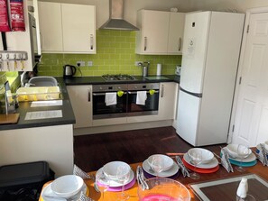 Kitchen with 2 full size ovens, microwave, dishwasher, fridge freezer, toaster