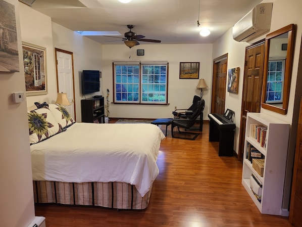 Large bedroom with queen bed ,TV and chairs