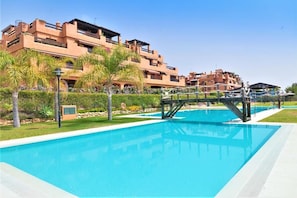 Fantastic communal swimming pool area surrounded by gardens