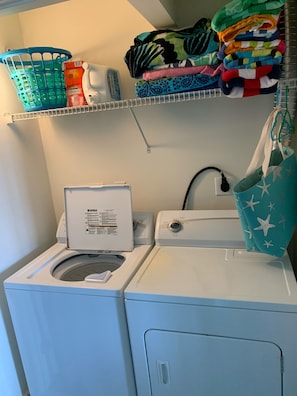 Full size washer and dryer in closet and laundry detergent. Lots of beach towels