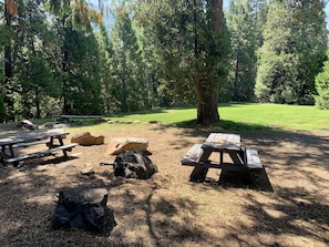 A bucolic meadow with al fresco dining fronts the cabins at Sequoia Meadows
