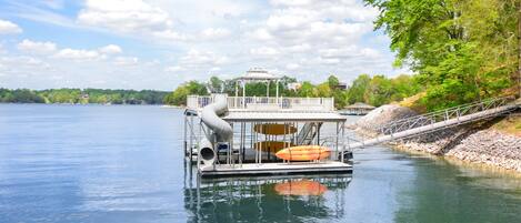 So much fun for the entire family at our deluxe floating dock! Relax on the second level adirondak chairs and slide down or take the plunge into deep water fro from the second level jump zone.