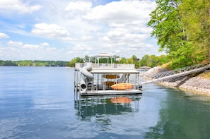 So much fun for the entire family at our deluxe floating dock! Relax on the second level adirondak chairs and slide down or take the plunge into deep water fro from the second level jump zone.