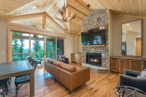 Living room with gas logs, 65" TV, Netflix, Disney+, Hulu, AT&T TV, ESPN+, and Alexa enabled high fidelity Smart speakers.