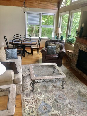 Living room with luxury comfortable furnishings & stacked stone fireplace