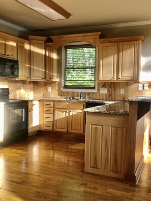 Large kitchen with granite countertops and breakfast bar