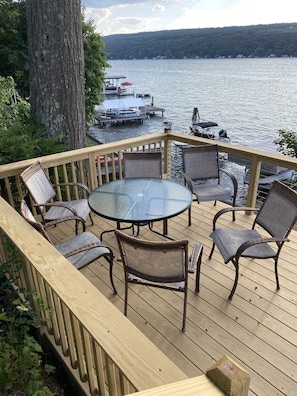 Upper deck with lots of seating and an umbrella for afternoon shade