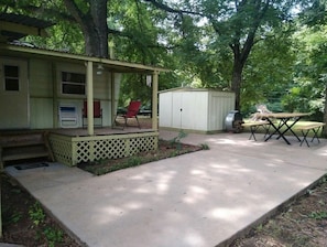 Large concrete patio with small covered porch