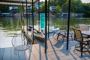 Relaxation awaits... lily pad, kayaks, paddle boards, swings, lounge chairs...