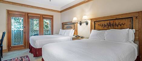 Suite features two Queen Beds and access to a balcony.