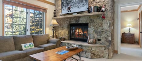 Living Room with Large Flat Screen Smart TV with Cable and Wood Burning Fireplace