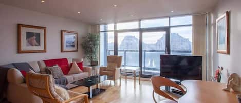 Lounge/workspace area, with balcony and views of river Clyde