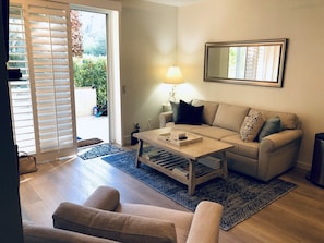 Living room has plenty of light from adjoining patio.