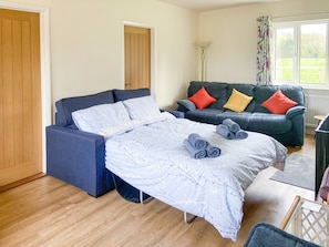 Sofa bed set up in living area | Old Alton Hall Farmhouse, Holbrook, near Ipswich