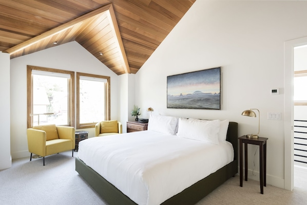 Main bedroom with beautiful vaulted wood ceiling over the window nook