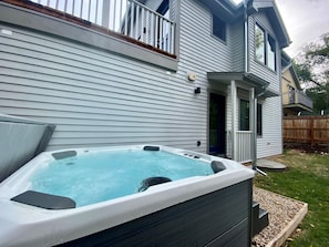 Jetted hot tub in the privacy of the backyard