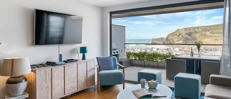 SeaEsta, Portreath. First floor: Sitting area with Smart television and bi-fold doors to large balcony