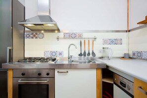 A compact and functional kitchen with modern appliances, sleek countertops, and overhead storage.
