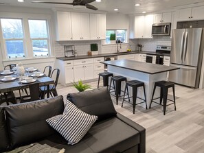 Alternate view of kitchen and dinning room area.  The couch is also a bed.