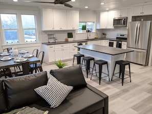 Alternate view of kitchen and dinning room area.  The couch is also a bed.