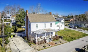 Aerial view of house showing parking pad and large back yard

