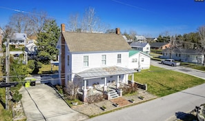 Aerial view of house showing parking pad and large back yard

