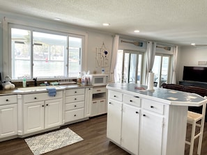 Kitchen open to living room with lake views everywhere
