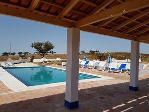 When the heat becomes too much, there's plenty of room for all under the pergola